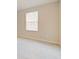 Empty bedroom featuring a window that provides natural light and neutral carpeting at 463 Cape Honeysuckle Pl, Sanford, FL 32771