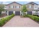 Beautiful townhomes featuring brick driveways, attached garages and manicured landscaping at 463 Cape Honeysuckle Pl, Sanford, FL 32771