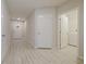 Bright hallway with neutral paint, modern doors, and wood-look flooring at 463 Cape Honeysuckle Pl, Sanford, FL 32771