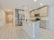 Modern kitchen featuring a center island, stainless steel appliances, and tile floors at 463 Cape Honeysuckle Pl, Sanford, FL 32771