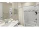 Bright bathroom featuring a shower over tub with white tiling and brushed chrome fixtures at 5065 Sparkling Water Way, Kissimmee, FL 34746