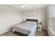 Simple bedroom with a bed, side tables, and two bright windows with blinds at 5065 Sparkling Water Way, Kissimmee, FL 34746