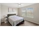 Bedroom featuring a comfortable bed, side tables with lamps, and two bright windows at 5065 Sparkling Water Way, Kissimmee, FL 34746