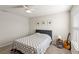 Neutral colored bedroom with a patterned quilt, a guitar and ocean themed wall art at 5065 Sparkling Water Way, Kissimmee, FL 34746