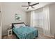 Cozy bedroom with a ceiling fan, a patterned duvet cover and ample natural light at 5065 Sparkling Water Way, Kissimmee, FL 34746