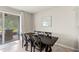 Bright dining room featuring a dark wood table, chairs, and sliding glass doors to the outdoor space at 5065 Sparkling Water Way, Kissimmee, FL 34746