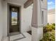 A close-up view showcases a stylish front door with decorative glass, modern hardware, and a charming entryway at 5065 Sparkling Water Way, Kissimmee, FL 34746