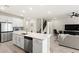 Open concept kitchen featuring a center island with bar seating, stainless steel appliances, and easy access to living spaces at 5065 Sparkling Water Way, Kissimmee, FL 34746