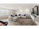 Cozy living room featuring a large sectional couch, a flat-screen TV and recessed lighting at 5065 Sparkling Water Way, Kissimmee, FL 34746
