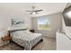 Comfortable main bedroom featuring a ceiling fan, artwork, and natural light from the window at 5065 Sparkling Water Way, Kissimmee, FL 34746