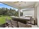 Outdoor kitchen with bar seating, grill, and sink, perfect for entertaining at 5065 Sparkling Water Way, Kissimmee, FL 34746