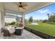 Screened patio boasts comfortable seating and a lovely view of the backyard and lake in the distance at 5065 Sparkling Water Way, Kissimmee, FL 34746