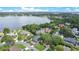 Picturesque aerial view of waterfront houses nestled along a serene lake and verdant landscape at 6317 Cheryl St, Orlando, FL 32819