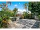 A lush backyard offers both natural beauty and modern comforts with its pool, outdoor kitchen, and stylish seating areas at 6317 Cheryl St, Orlando, FL 32819