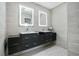 Modern bathroom featuring double sinks with dark wood cabinetry and illuminated mirrors at 6317 Cheryl St, Orlando, FL 32819