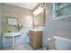 Bathroom featuring a wooden vanity, grey tile backsplash, and a round accent table at 6317 Cheryl St, Orlando, FL 32819