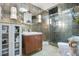 Bathroom with decorative mirror, tiled walls, glass shower and unique lighting at 6317 Cheryl St, Orlando, FL 32819