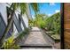 The side yard walkway showcases the meticulous landscaping and architectural harmony of this property at 6317 Cheryl St, Orlando, FL 32819
