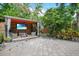 Charming outdoor gazebo with TV, seating and a ceiling fan is surrounded by lush tropical foliage offering a relaxing private space at 6317 Cheryl St, Orlando, FL 32819