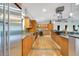 Spacious kitchen with stainless steel refrigerator, wine cooler, granite countertops and plenty of wood cabinetry at 6317 Cheryl St, Orlando, FL 32819