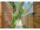 Pathway between two wooden fences leads to the home's entrance, promising a sense of discovery and privacy at 6317 Cheryl St, Orlando, FL 32819