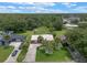 Charming home with a long driveway and large backyard with lush greenery and mature trees at 708 Duffer Ln, Kissimmee, FL 34759