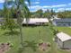 Aerial view of a home with a screened-in patio, mature trees, and a convenient storage shed at 708 Duffer Ln, Kissimmee, FL 34759
