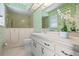 The bathroom features green wallpaper, a walk-in shower, and vanity with cabinet at 708 Duffer Ln, Kissimmee, FL 34759