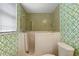 Featuring green wallpaper, walk in shower and handicap support bars at 708 Duffer Ln, Kissimmee, FL 34759