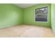 Bedroom features a window, green walls, and neutral carpet at 708 Duffer Ln, Kissimmee, FL 34759