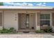 Inviting front entrance with a beige door, brick pathway, and well-maintained landscaping at 708 Duffer Ln, Kissimmee, FL 34759