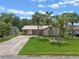 Charming single-story home featuring a beige exterior, metal roof, and a well-manicured lawn at 708 Duffer Ln, Kissimmee, FL 34759