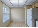 Bright kitchen space with white refrigerator, neutral walls and checkered floors at 708 Duffer Ln, Kissimmee, FL 34759