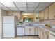 Kitchen with lighter wood cabinets, white appliances, and tiled backsplash at 708 Duffer Ln, Kissimmee, FL 34759