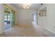 Living room featuring neutral walls, carpet floors, and a sliding door to the enclosed patio at 708 Duffer Ln, Kissimmee, FL 34759