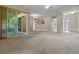 Spacious living room with neutral carpet and sliding glass doors to the outside at 708 Duffer Ln, Kissimmee, FL 34759