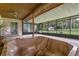 Relaxing enclosed outdoor space featuring a built-in hot tub with views to the spacious backyard at 708 Duffer Ln, Kissimmee, FL 34759
