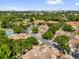 A community aerial view shows tree-lined streets and well-kept homes at 7421 Sugar Bend Dr # 7421, Orlando, FL 32819