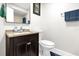 Clean bathroom with a dark vanity, light countertop, and a large mirror at 7421 Sugar Bend Dr # 7421, Orlando, FL 32819