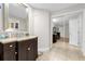 Bathroom featuring dark vanity, spacious mirror, and tile floors at 7421 Sugar Bend Dr # 7421, Orlando, FL 32819