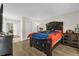 Spacious bedroom with hardwood floors, closet, and a decorative headboard at 7421 Sugar Bend Dr # 7421, Orlando, FL 32819