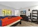 Cozy bedroom with a dresser, TV, sports decor, and wood-look floors at 7421 Sugar Bend Dr # 7421, Orlando, FL 32819