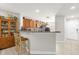 Well-lit kitchen featuring stainless steel appliances, countertop seating and white flooring at 7421 Sugar Bend Dr # 7421, Orlando, FL 32819