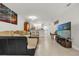 Open living space with tile floors, a kitchen counter with bar stools, and a view of the TV at 7421 Sugar Bend Dr # 7421, Orlando, FL 32819