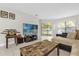 Bright living room with tile flooring, large windows, and sliding glass doors to the outdoor space at 7421 Sugar Bend Dr # 7421, Orlando, FL 32819