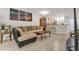 Open-concept living area featuring tile flooring, a plush sofa, and a seamless flow into the kitchen at 7421 Sugar Bend Dr # 7421, Orlando, FL 32819