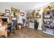 Well-organized office with a desk, shelves filled with books and trophies, and wood floors at 7421 Sugar Bend Dr # 7421, Orlando, FL 32819