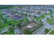 An aerial perspective of a residential community with houses adorned with solar panels and a nearby playground at 9069 Pinch Shot Dr, Winter Garden, FL 34787
