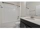 Bright bathroom features a shower over tub and vanity with modern fixtures at 9069 Pinch Shot Dr, Winter Garden, FL 34787