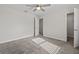 Spacious bedroom with ceiling fan, carpet, neutral walls and access to an ensuite bathroom and closet at 9069 Pinch Shot Dr, Winter Garden, FL 34787